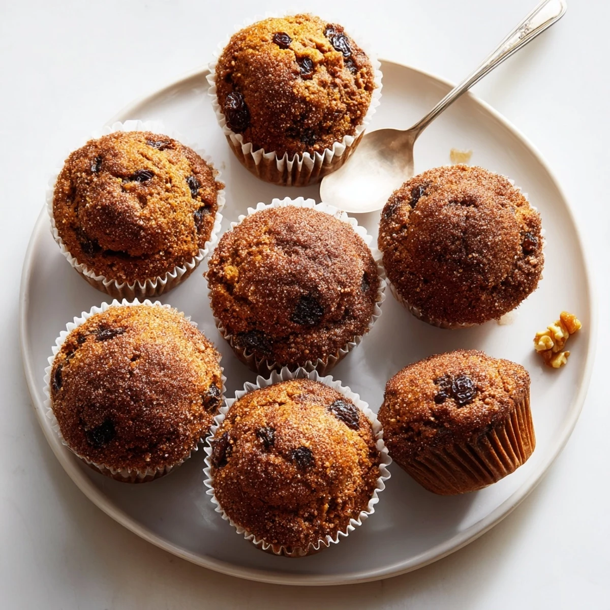 Aromatic ginger-spiced pumpkin muffins cooling on a wire rack, ideal for afternoon snacks.  
