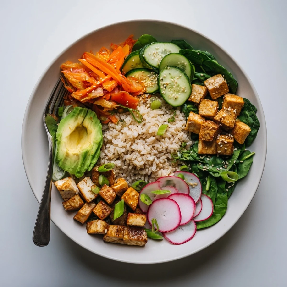 Wholesome fermented vegetable bowl with creamy avocado and hearty brown rice base.  