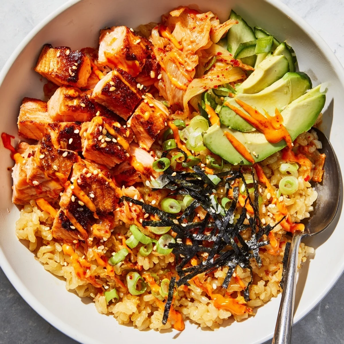 Crispy Salmon Rice Bowl topped with creamy spicy mayo and vibrant kimchi.