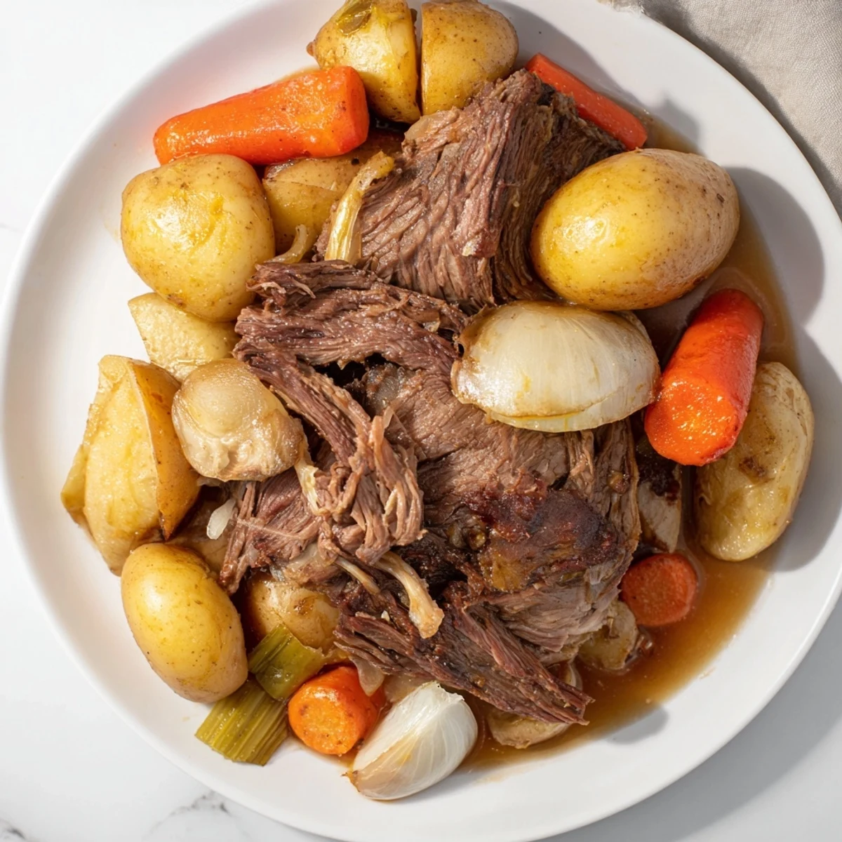 Tender Sunday Pot Roast with vegetables, glistening, served on a warm plate for a hearty dinner.