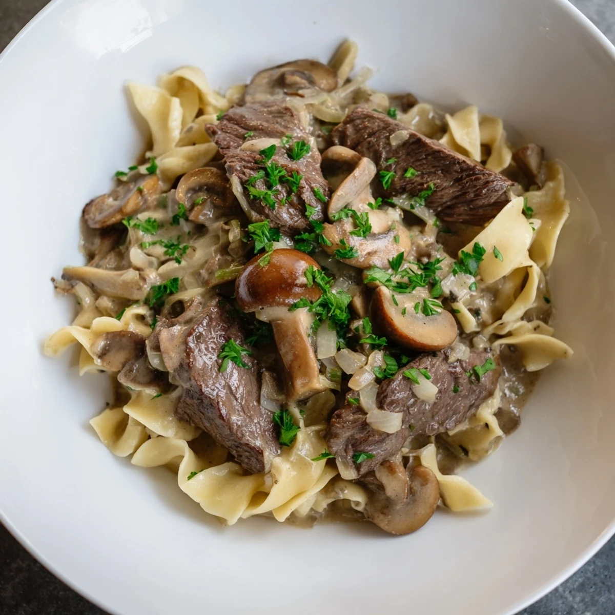 Savory Creamy Mushroom Beef Stroganoff: a comforting view of the classic dish, perfectly garnished with parsley.