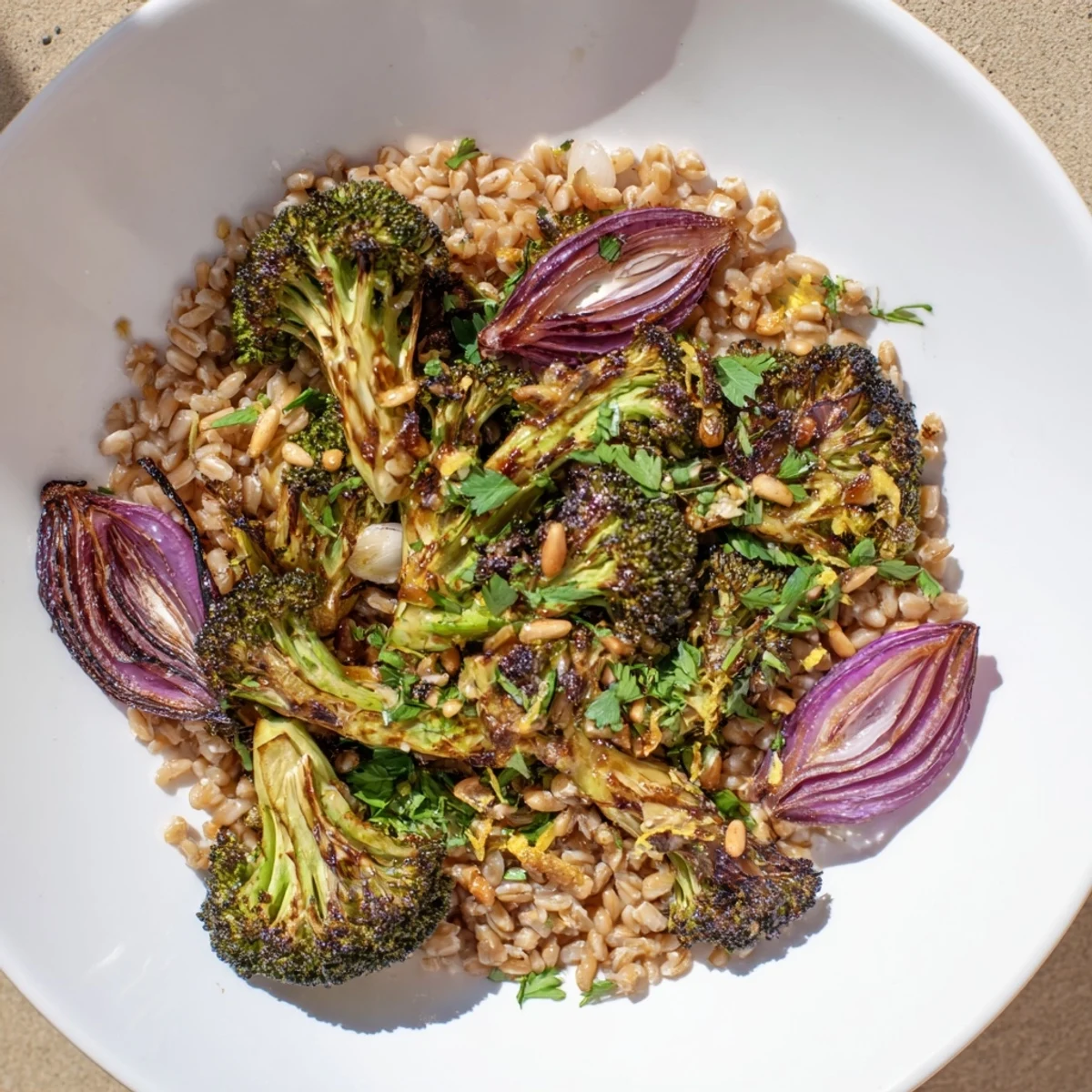 Vibrant image of warm roasted broccoli over nutty farro, a healthy and flavorful Mediterranean dish.