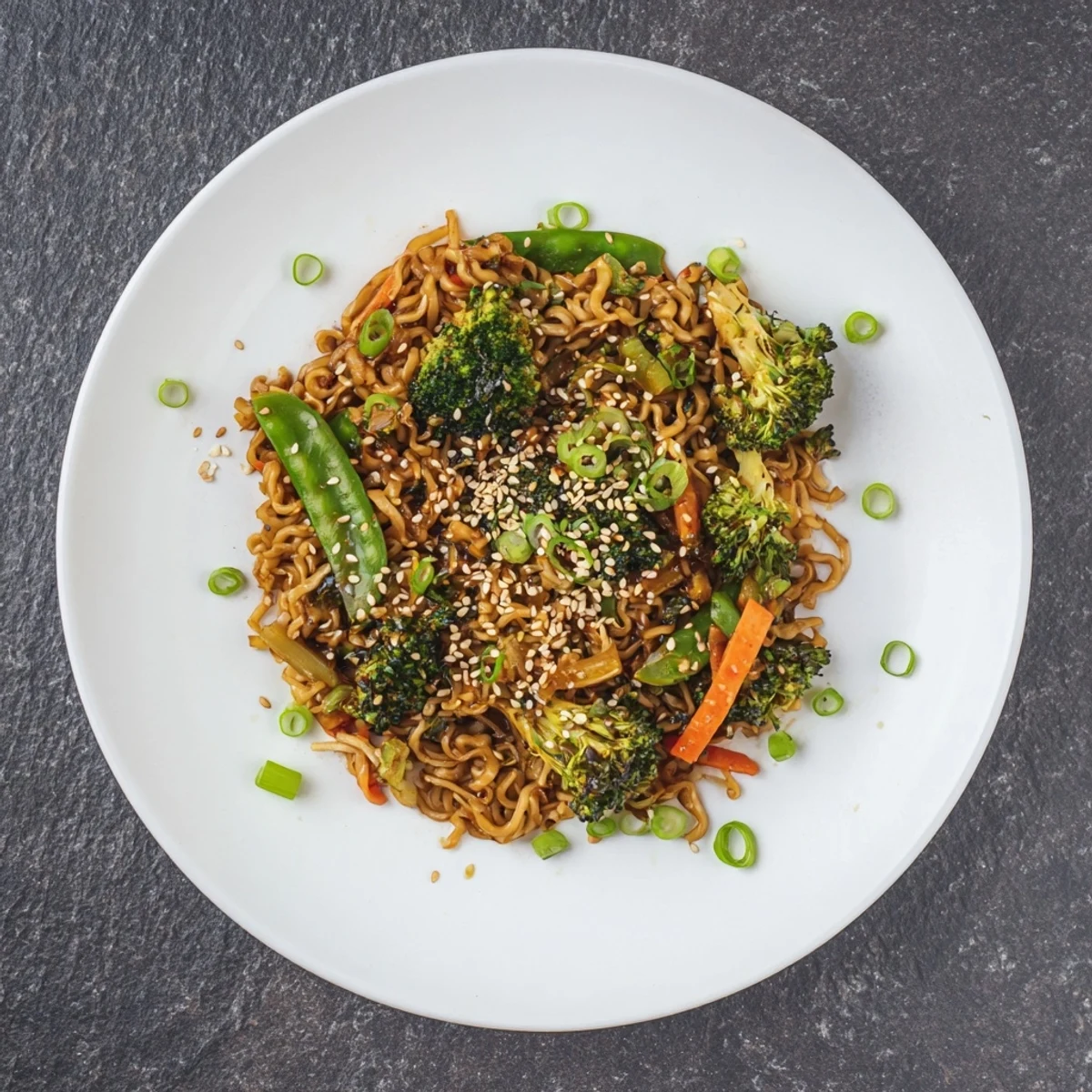 This quick Ramen Noodle Stir-Fry Remix shows perfectly cooked noodles with toasted sesame seeds on top.