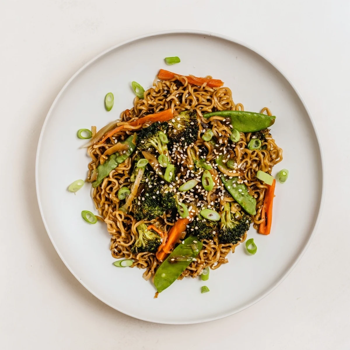 Steaming bowl of Ramen Noodle Stir-Fry Remix, colorful with vegetables and a savory sauce.