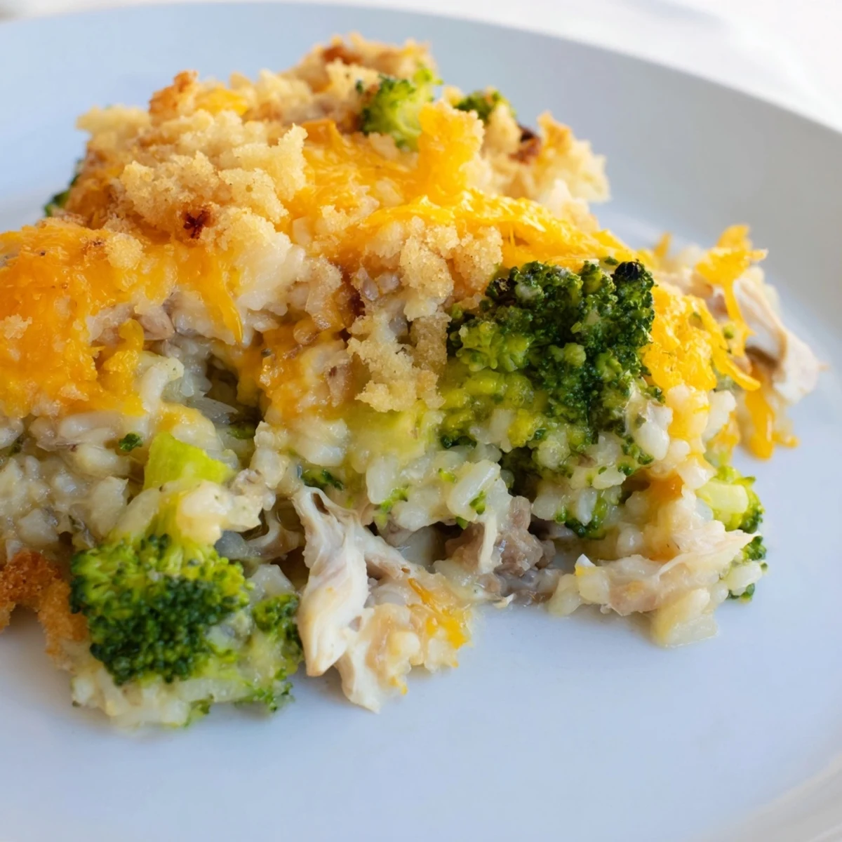 Enjoy a hearty serving of Chicken & Broccoli Rice Casserole with seasoned breadcrumb topping and savory sauce.
