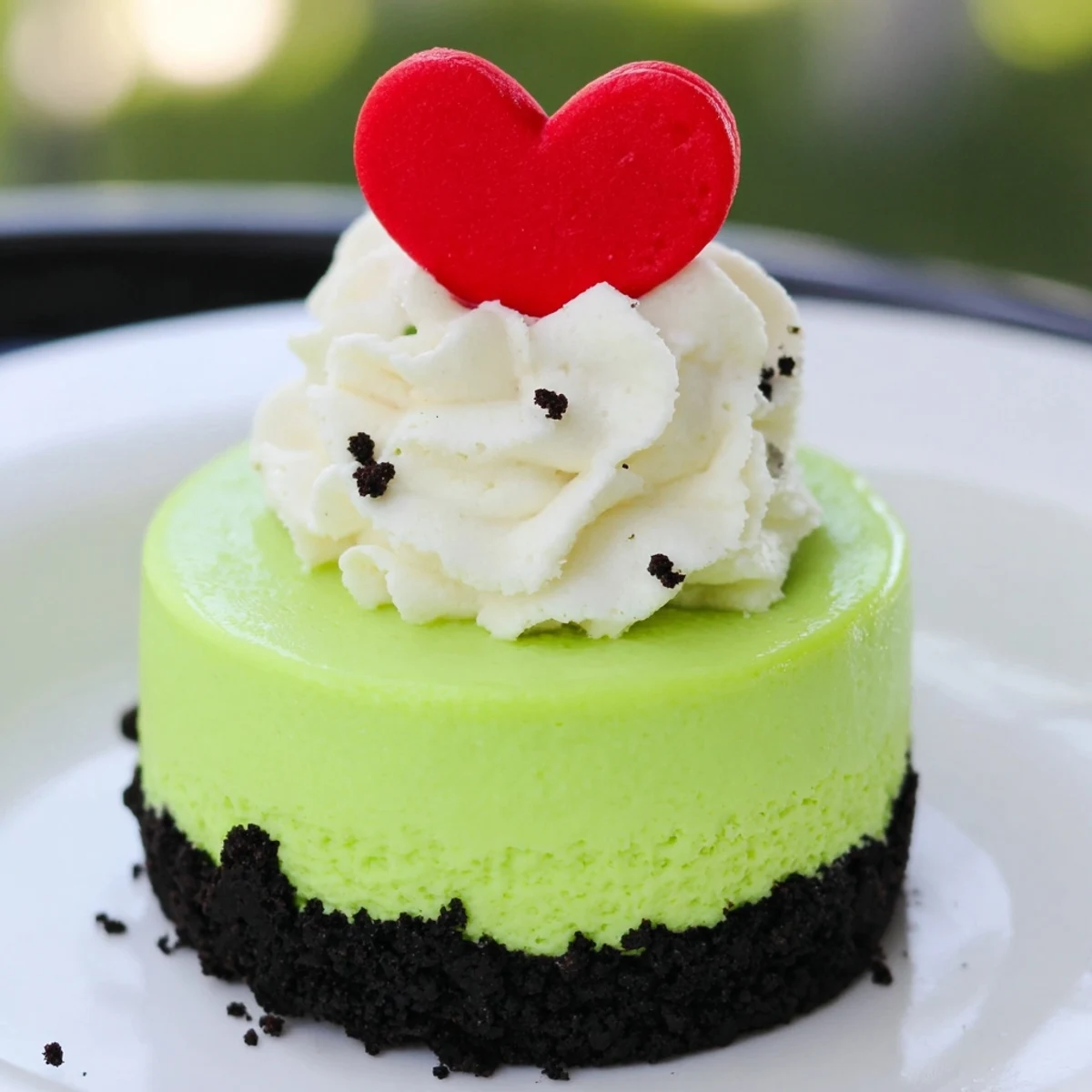 Festive, creamy Grinch Mini Cheesecakes with a bright green filling, ideal for Christmas dessert.