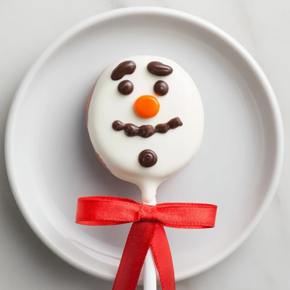 Festive Express Snowman Marshmallow Pops, complete with orange noses and candy scarves, perfect for holiday gifts.