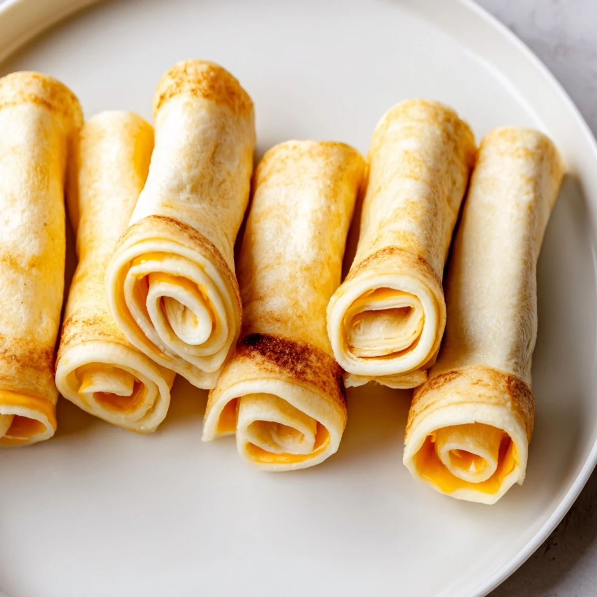 These Easy Christmas Grilled Cheese Rollups, rolled and cooked to perfection, offer a delightful cheesy experience.