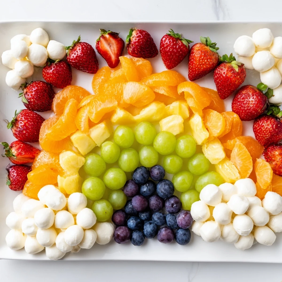 Rainbow Cloud Snack Board bursting with colorful fruits and savory veggies, perfect for a party snack.