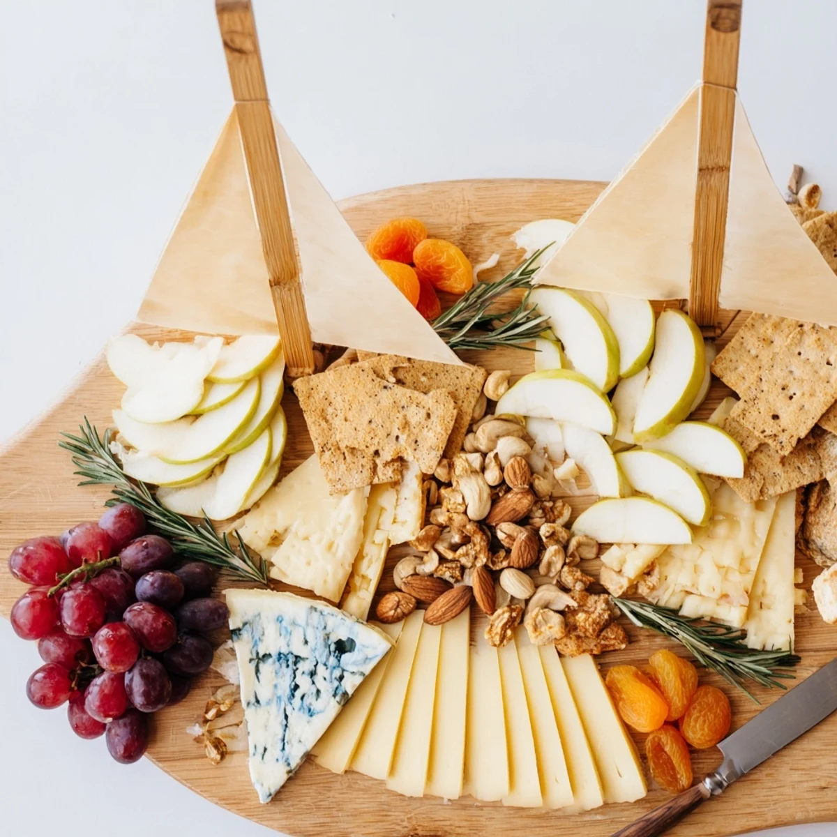 A beautifully arranged Sailboat Cheese Platter, offering a delightful array of cheeses and fruits.