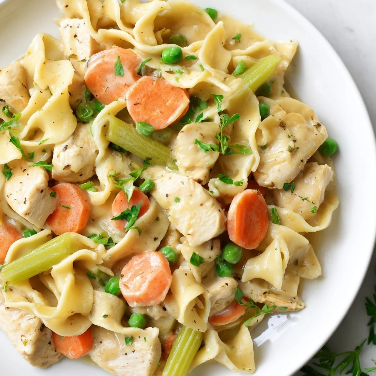 Savory Creamy Chicken and Egg Noodles with herbs and vegetables, a home-cooked American meal.
