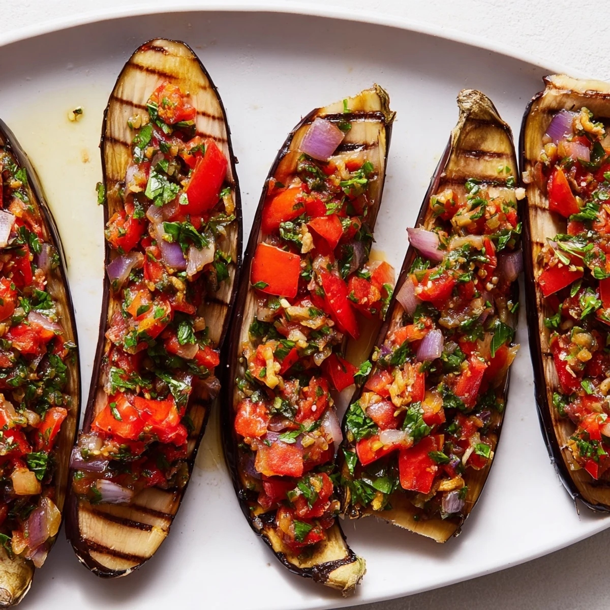 Golden-brown Imam Bayildi, the Turkish eggplant dish, bubbling with a rich tomato filling and herbs.