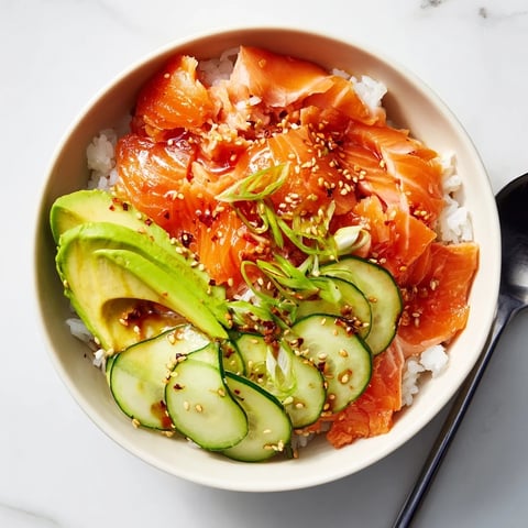 A flavorful leftover salmon and rice bowl, topped with fresh avocado and cucumber.  