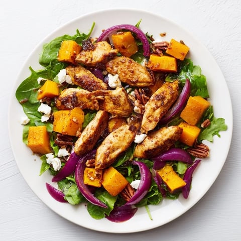 Roasted chicken and winter squash sheet-pan salad with tender chicken alongside caramelized squash and vibrant greens.