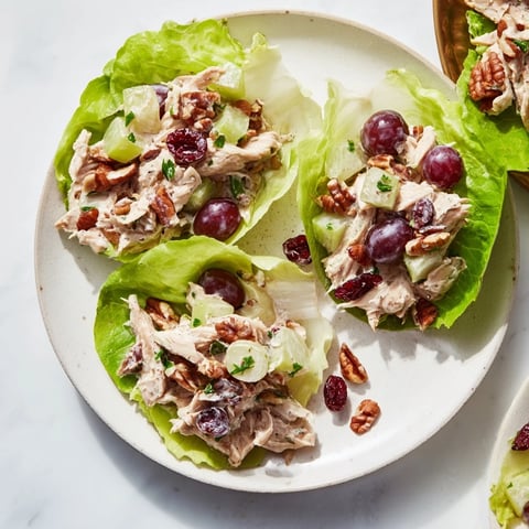 Fluffy chicken salad cups with grapes and pecans: a delightful appetizer for your festive table.