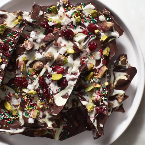 Festive holiday bark shards with peppermint, pistachios, and cranberries, a delicious dessert.