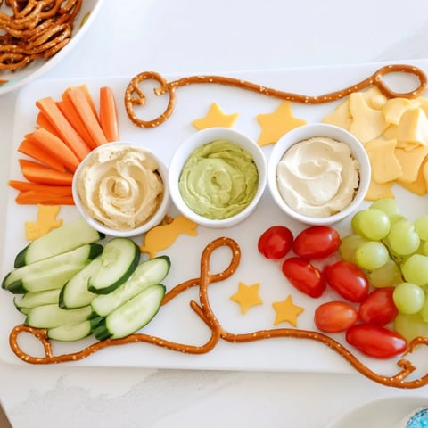 A colorful Kids Snack Adventure Map platter with pretzel paths leading to cheese and veggie treasures.