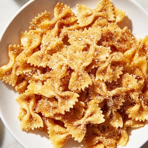 Golden, crispy Air Fryer Pasta Christmas Crack, a sweet and salty snack dusted with cinnamon sugar.