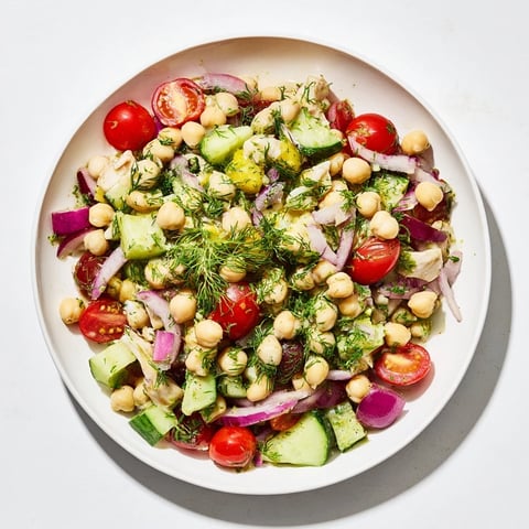 Dense Bean Salad with Lemon-Dill Chicken, featuring colorful vegetables and tender, shredded chicken.