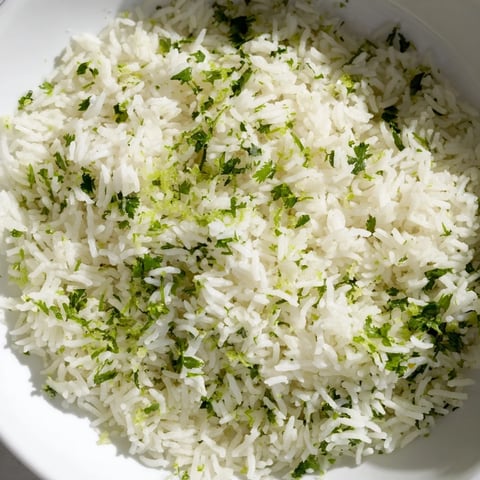 Fluffy Cilantro Lime Rice glistening with fresh cilantro and a squeeze of lime, ready to serve.