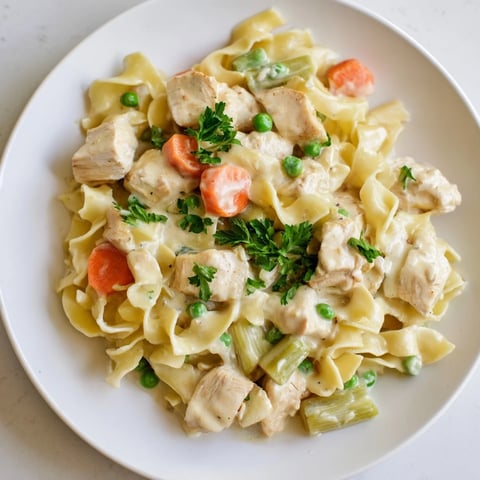 Creamy Chicken and Egg Noodles: A comforting plate of rich, creamy noodles with tender chicken.
