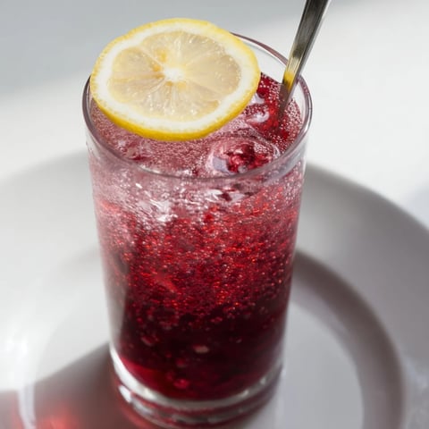 Refreshing Sleepy Girl Mocktail with tart cherry hues, served in a chilled glass, ready to sip.