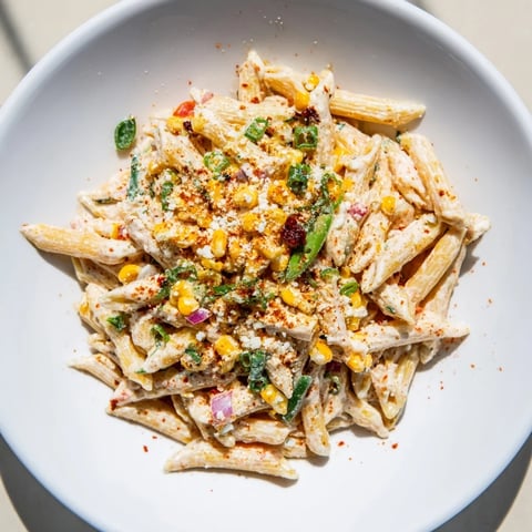 A colorful bowl of Mexican Street Corn Pasta, showcasing creamy pasta and charred corn.