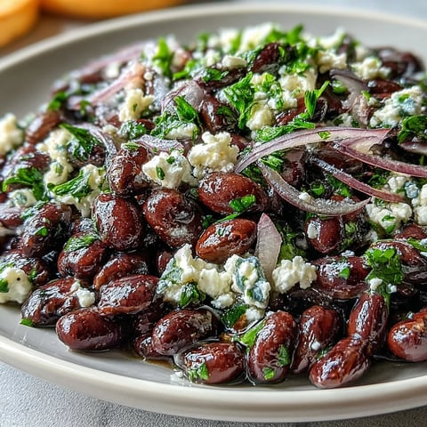 Crumbled feta and fresh parsley top the vibrant Divorce Salad, with red onions adding a crisp bite in a serving bowl.