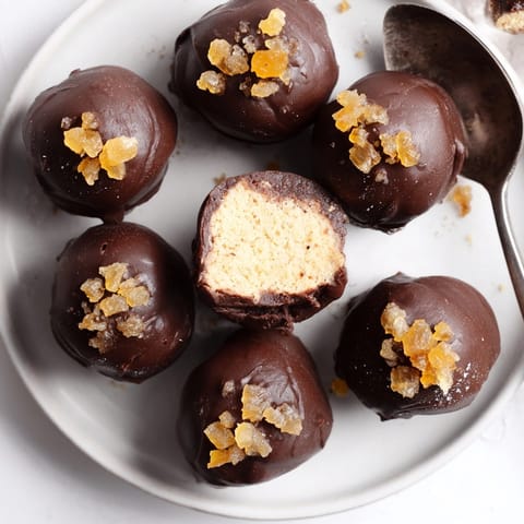 Homemade Cinnamon Ginger Ricotta Truffles: bite-sized desserts, showing a moist, spiced almond meal center.