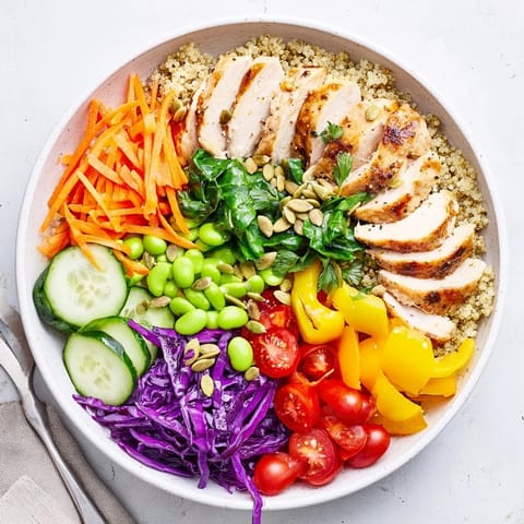 Vibrant healthy meal-prep bowls topped with zesty dressing and fresh herbs.  