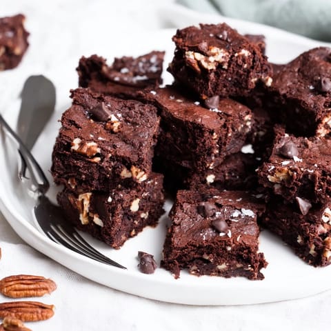 Savory nut-milk pulp brownies, warm and gooey, perfect for dessert lovers.  
