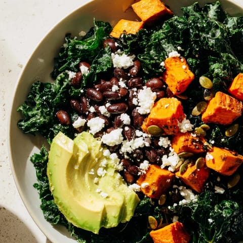 This massaged kale salad features tender kale, hearty black beans, and sweet potato with a zesty lime dressing.