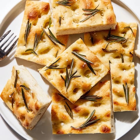 Warm, aromatic Holiday Bread focaccia topped with fragrant herbs, baked to a delicious crisp.