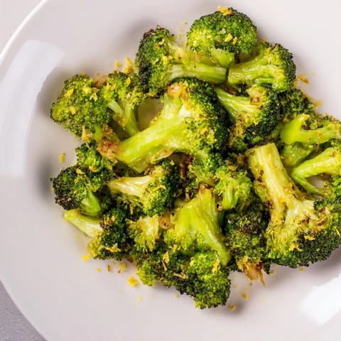 Bright green Lemon Garlic Roasted Broccoli glistens with olive oil, freshly roasted for a delicious bite.
