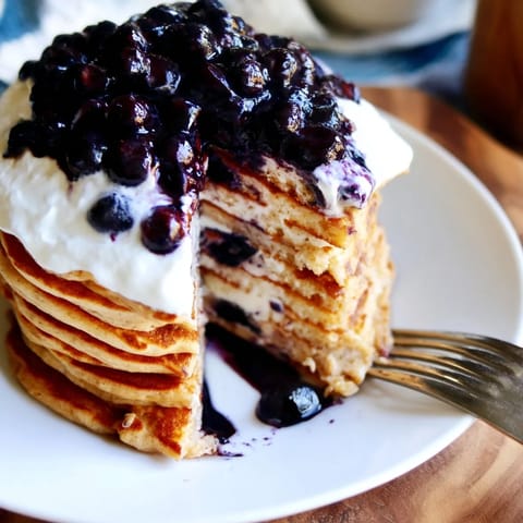 Fluffy Protein Power Pancakes sizzling in a non-stick skillet, with bubbles forming on the surface for a perfect breakfast.  