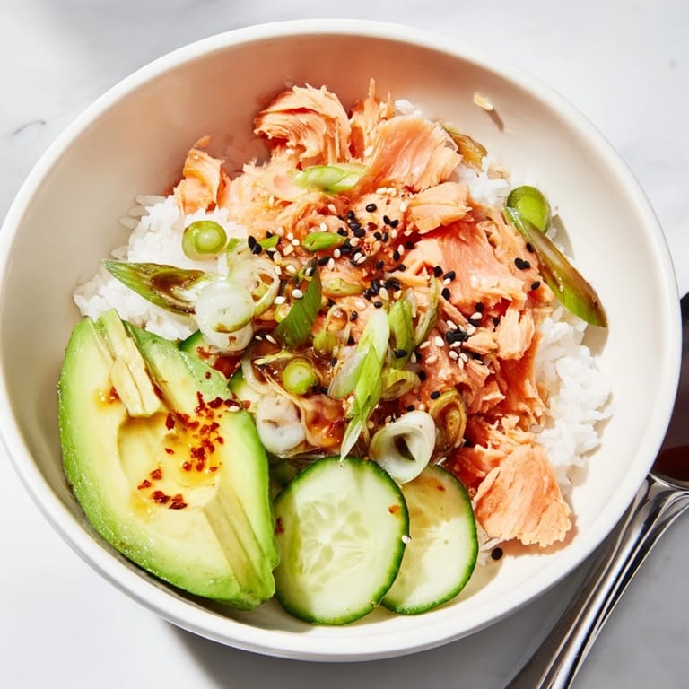 Revive your meal with this vibrant leftover salmon and rice bowl, garnished beautifully.  