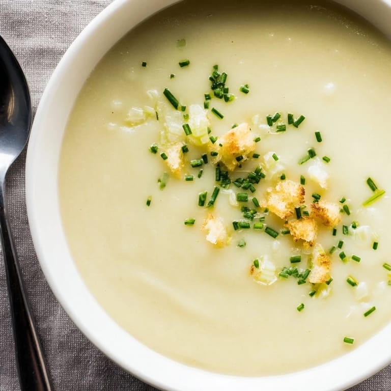Close-up of golden Potato Leek Soup, a classic French recipe perfect for a simple, cozy dinner.