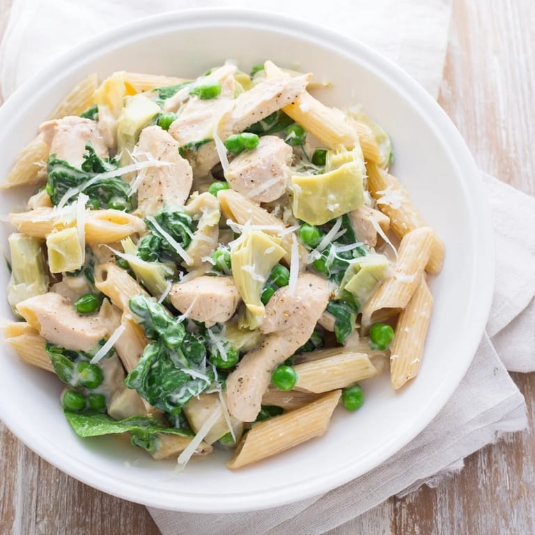 This savory Creamy Spinach Artichoke Protein Pasta Skillet looks warm and inviting, perfect for dinner.