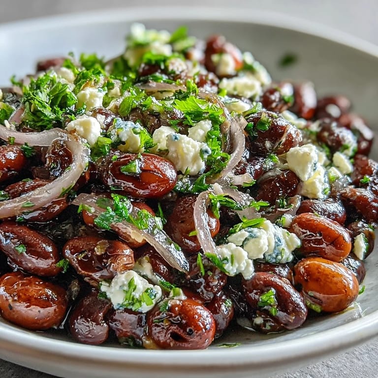 Chopped parsley and crumbled feta garnish the protein-packed Divorce Salad, with thinly sliced red onions mingling in a fresh medley.