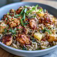 Sweet Chili Chicken Pineapple Fried Rice with colorful vegetables and juicy pineapple chunks in a savory-sweet sauce, served hot from the wok for a vibrant tropical meal.