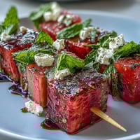 Watermelon Feta Mint Skewers with fresh mint and creamy feta, drizzled with olive oil for a refreshing summer appetizer.