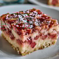 Golden Rhubarb Custard Bars with a buttery shortbread crust, ready for slicing.